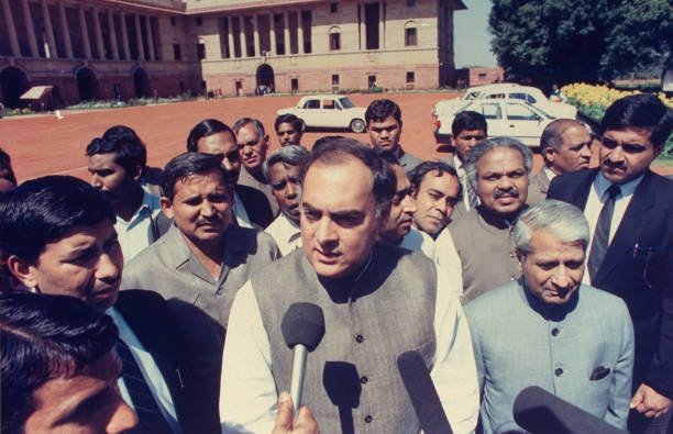 Opposition Congress Party ldr. former PM Rajiv Gandhi (C), speaking to press, outside, w. entourage in tow, during pol. maneuvering following PM Chandra Shekhar's resignation. (Photo by Robert Nickelsberg/Getty Images)