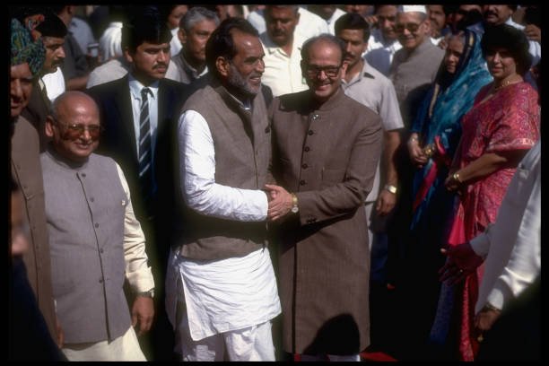 Janata Dal Party dissident ldr. Chandra Shekhar (R) embracing (resigned) PM Singh, outside pres. palace, after being asked form new govt. (Photo by Robert Nickelsberg/Getty Images)