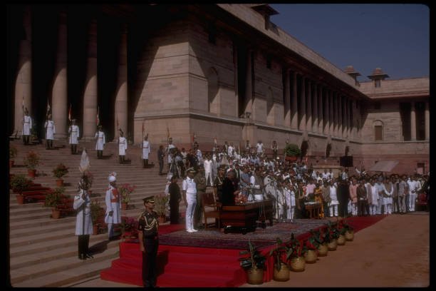 Janata Dal Party dissident ldr. Chandra Shekhar (C) speaking at ceremony outside pres. palace after being asked to form new govt. (Photo by Robert Nickelsberg/Getty Images)